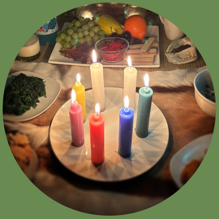 A candlelit altar with six colorful candles and various fruits and foods as offerings to ancestral spirits.